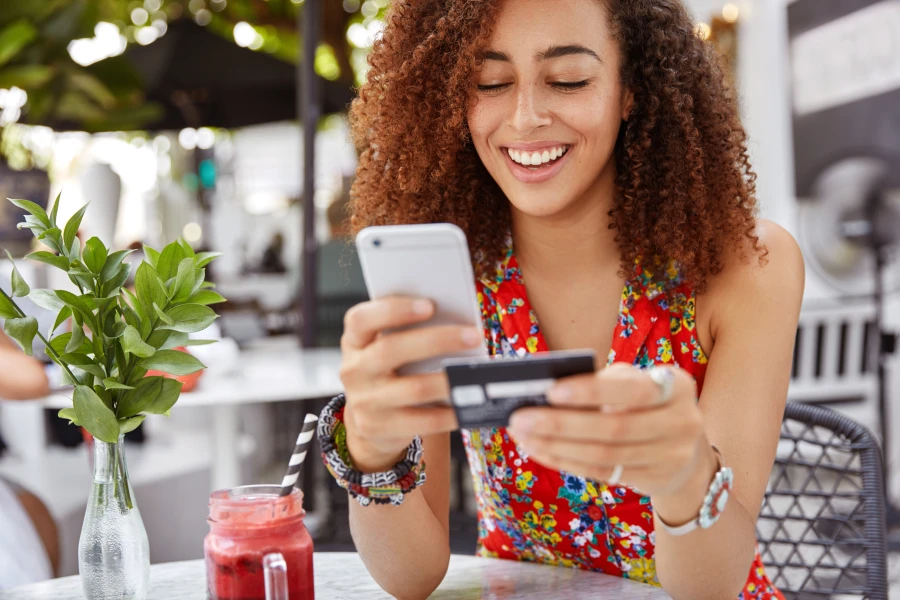 mulher-cabelos-cacheados-mexendo-em-celular